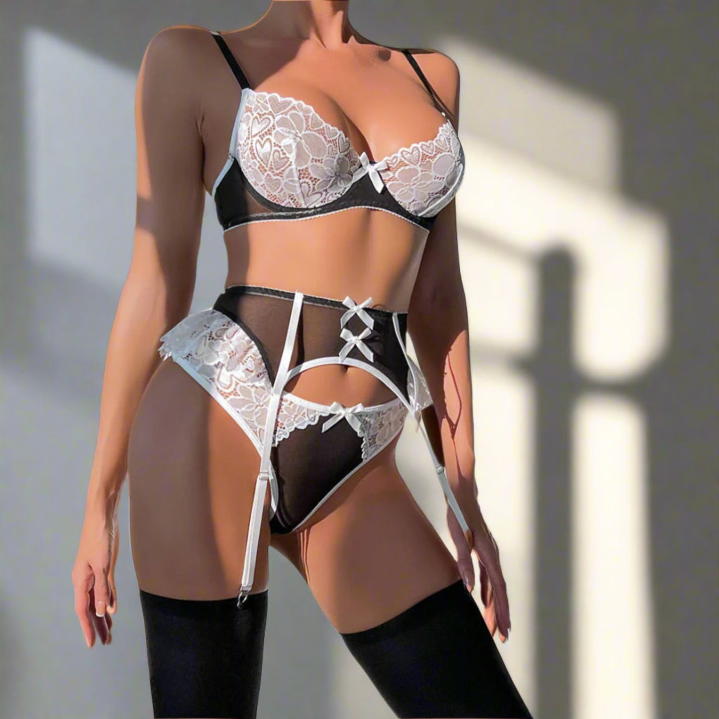 Lace lingerie set with black and white details on a neutral background