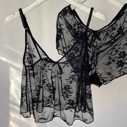 Black lace lingerie set on a white hanger against a white background