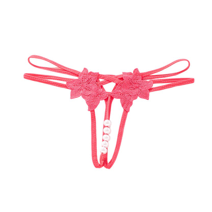 Pink lace thong with floral designs on a white background